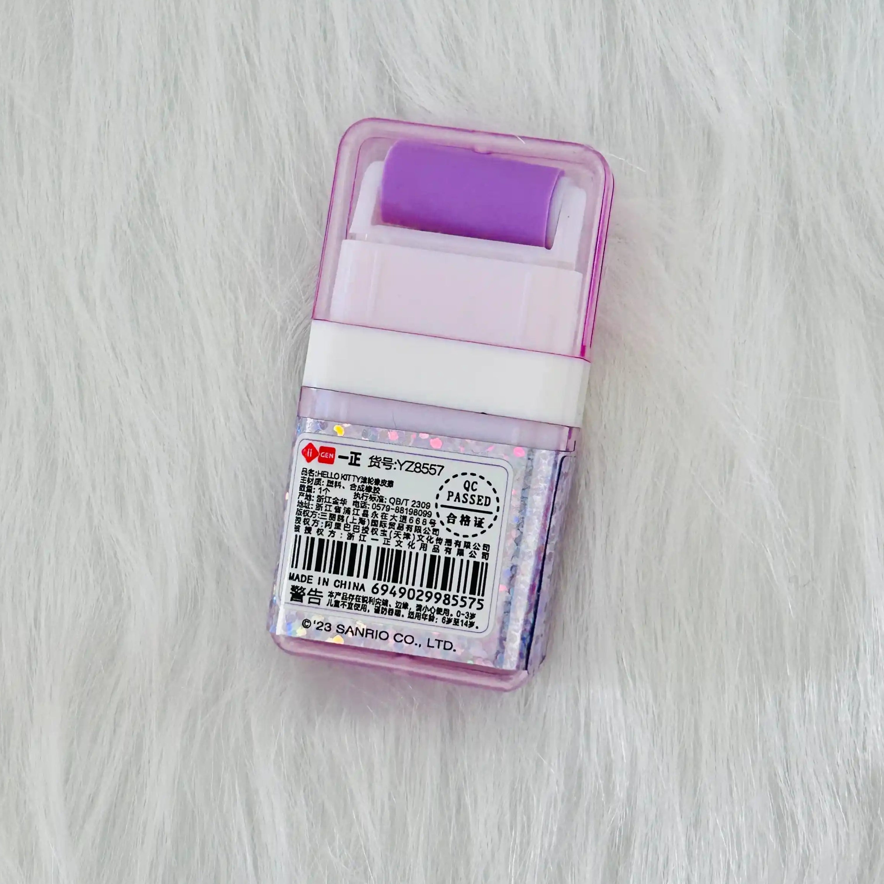 Back view of a purple Sanrio Hello Kitty Erasers with roller shavings collector, shows product details and barcode.