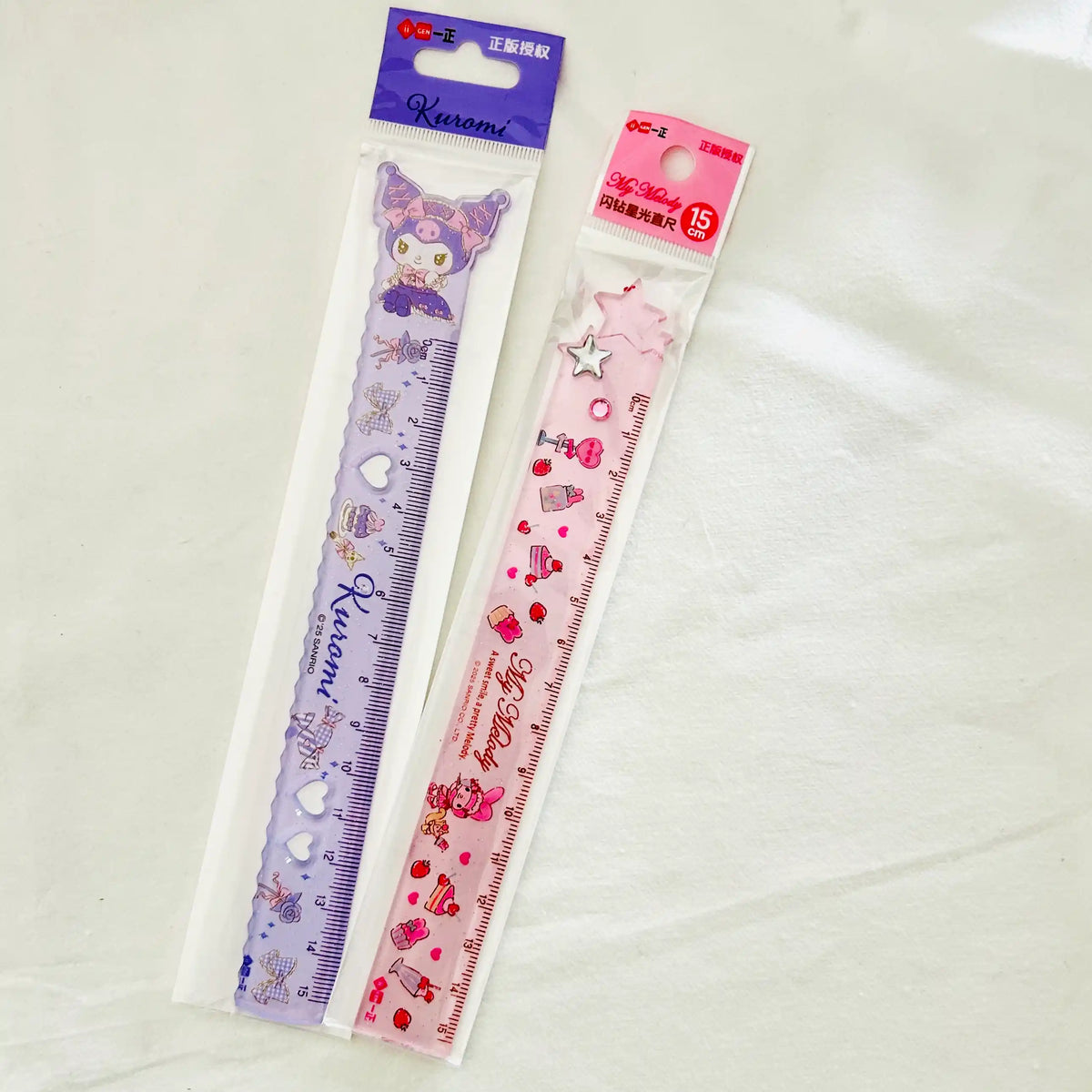 Two Sanrio-themed plastic ruler. One is lavender with Kuromi illustrations, and the other is pink with star and My Melody.