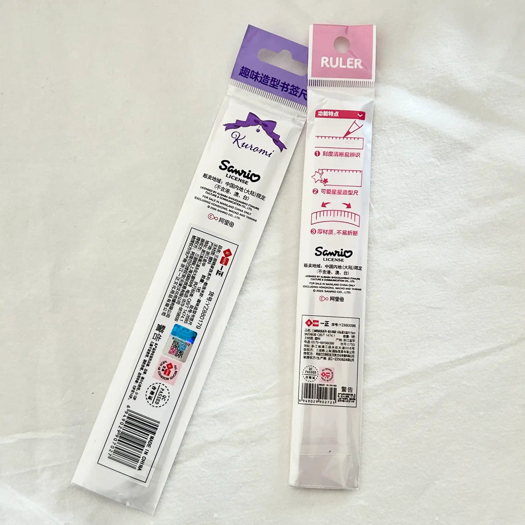 Two packaged Sanrio ruler, a purple package labeled 'Kuromi' and a pink package labeled 'RULER' with measurement guide graphics.