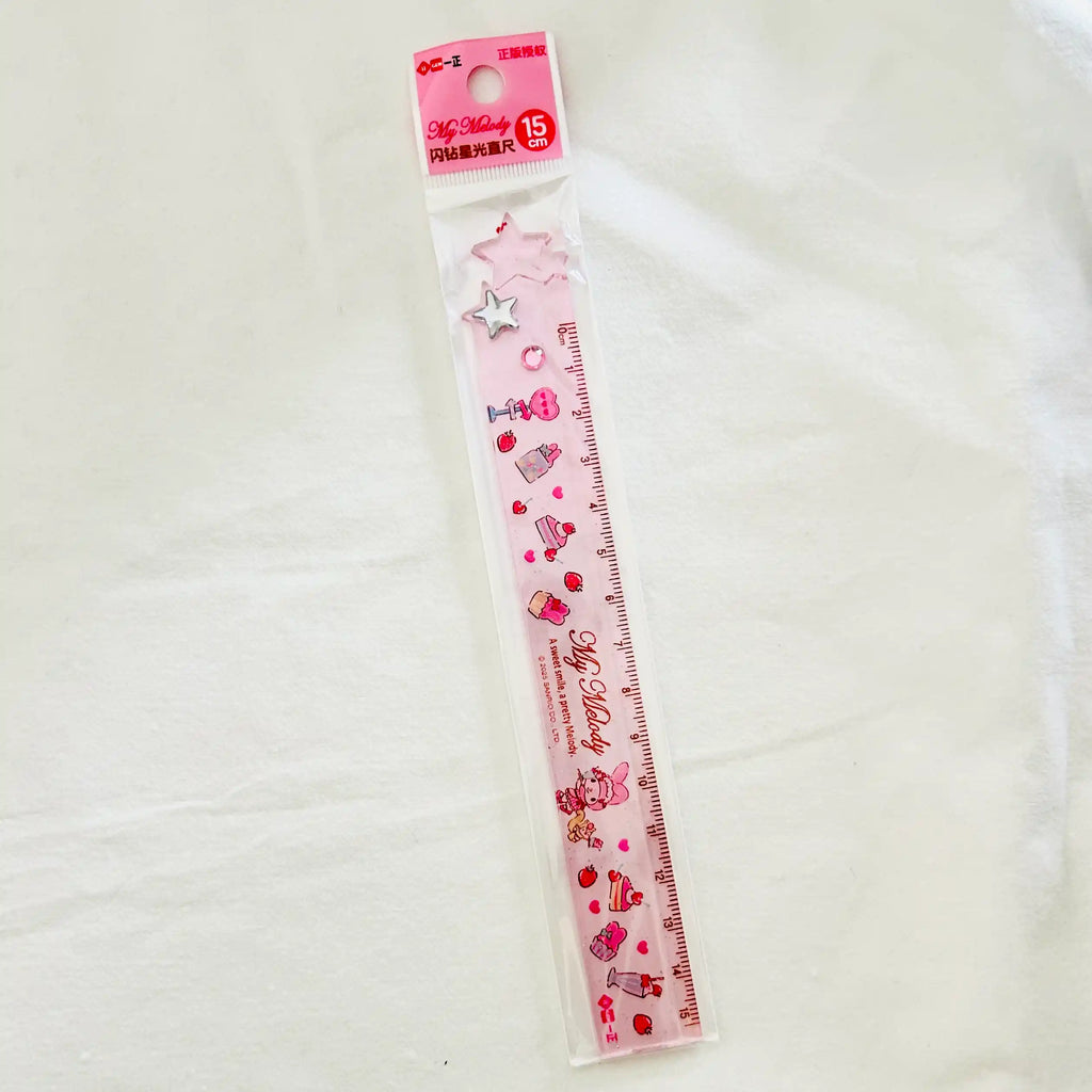 A pink My Melody plastic ruler in its clear plastic packaging, featuring cute illustrations of cakes, hearts, and stars.