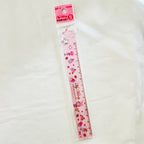 A pink My Melody plastic ruler in its clear plastic packaging, featuring cute illustrations of cakes, hearts, and stars.