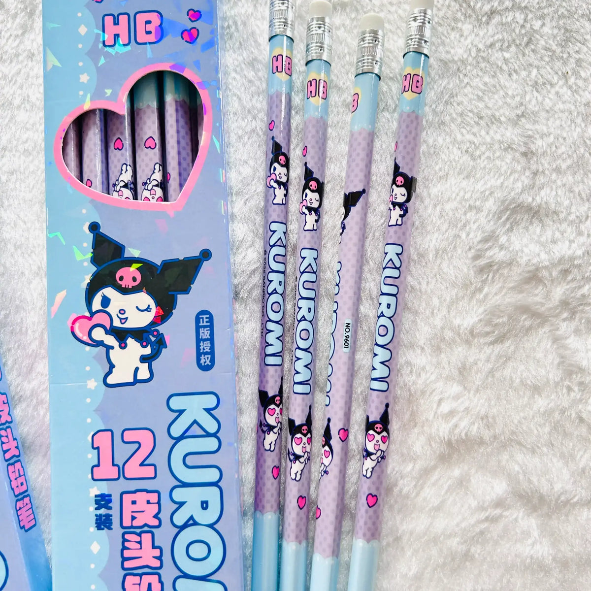 Close up view of the Kuromi branded HB pencils with purple glitter bodies and light blue ends.