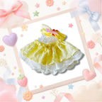 The back view of the clothing set that include yellow ruffled dress with a floral bow