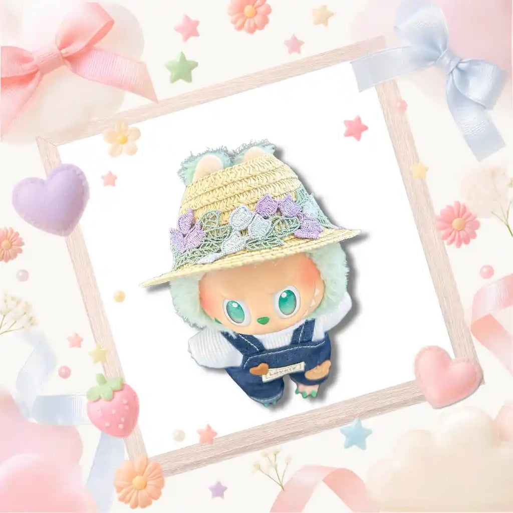 The front view of Labubu wearing the indigo denim overalls and floral straw sun hat.