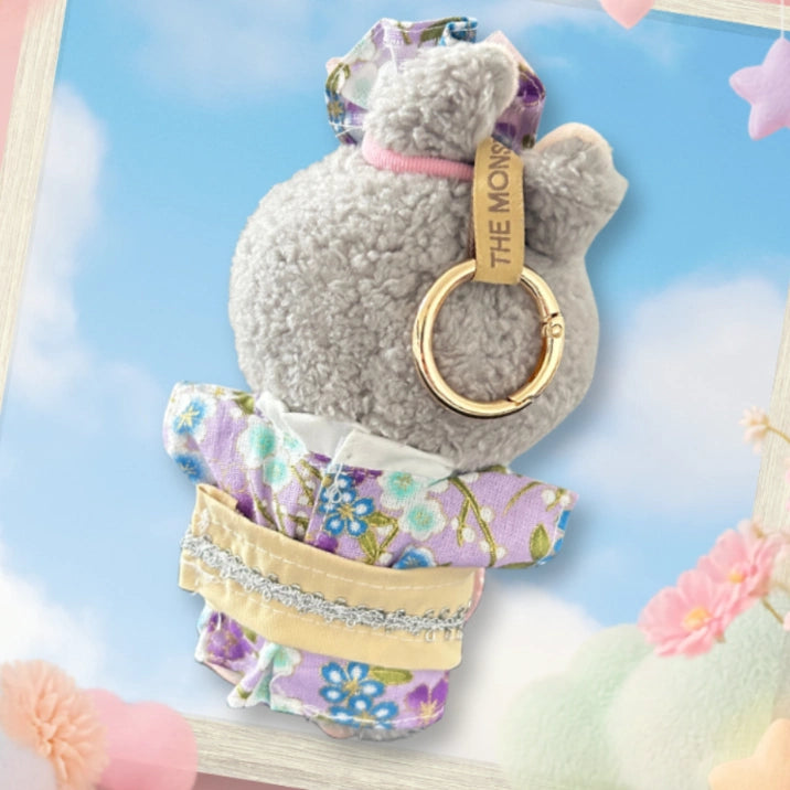 A back view Labubu wearing a clothing set of purple floral kimono and tulle hairpiece.