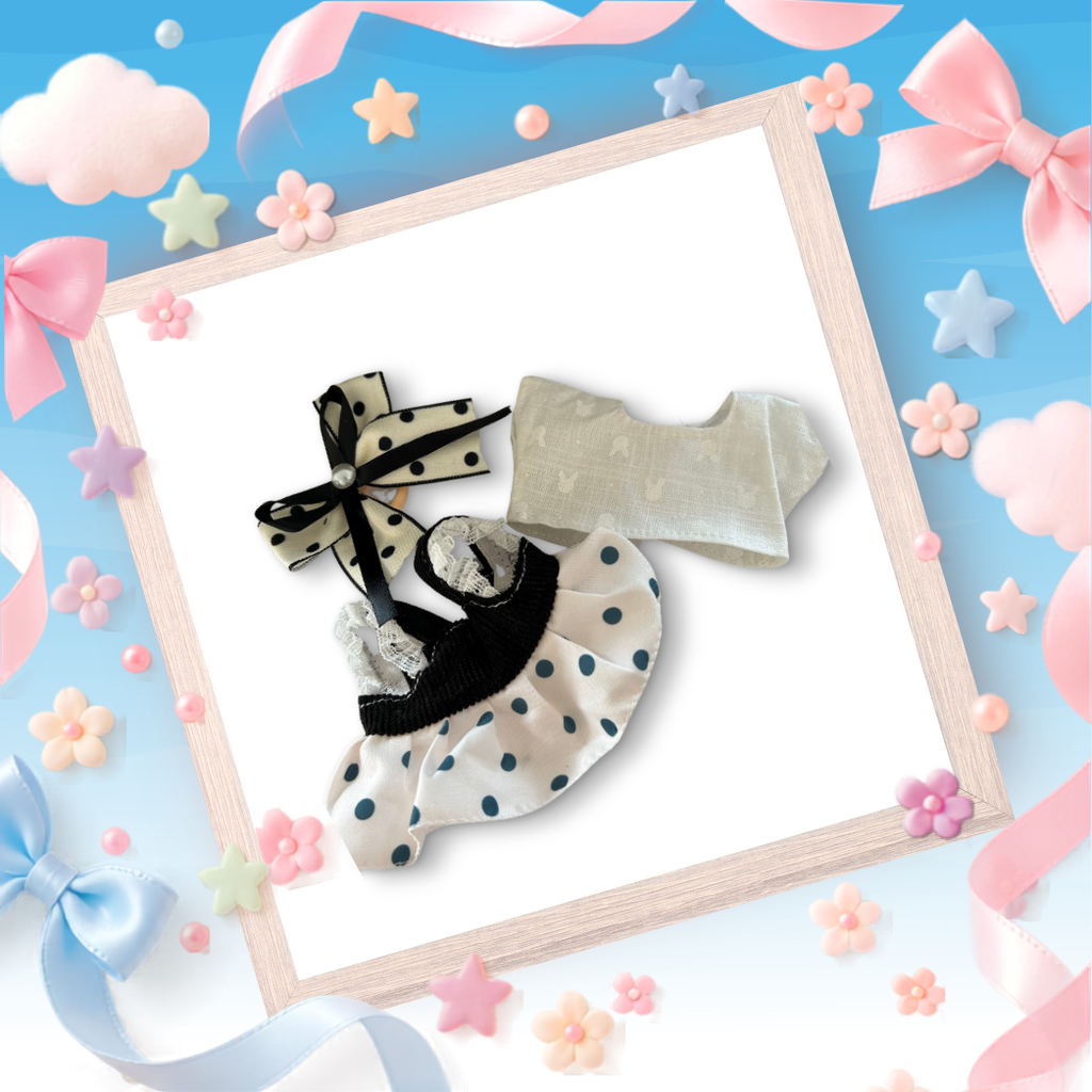 The front view of the clothing set that include black polka dot pinafore and oversized pearl bow