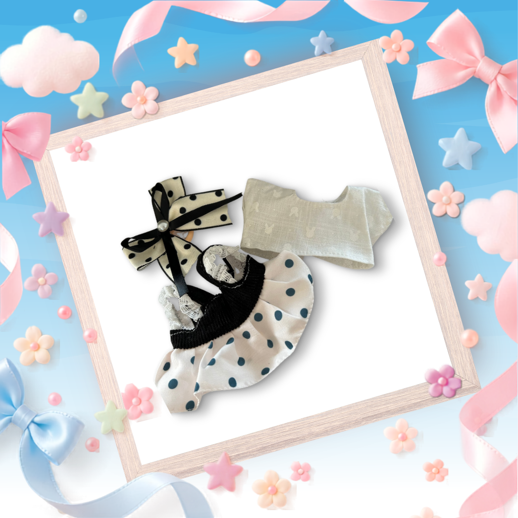 The front view of the clothing set that include black polka dot pinafore and oversized pearl bow