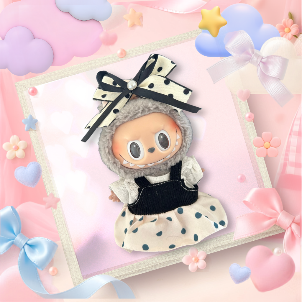 A front view Labubu wearing a clothing set of black polka dot pinafore and oversized pearl bow