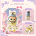 Labubu Doll Dress outfit variation graphic showing a plush doll in a yellow gingham dress with leaf print, and a large bow headband. 