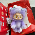 A purple fuzzy Labubu Have a Good Rub plush toy, placed on top of a red printed box and bag.  