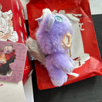 A Have a Good Run Series Labubu plush character in lavender-purple with white accents, resting on red packaging and box.