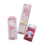 Three pink My Melody stationery items in retail packaging on a pastel lavender background: a pen, a set of three pencils, and a small eraser.