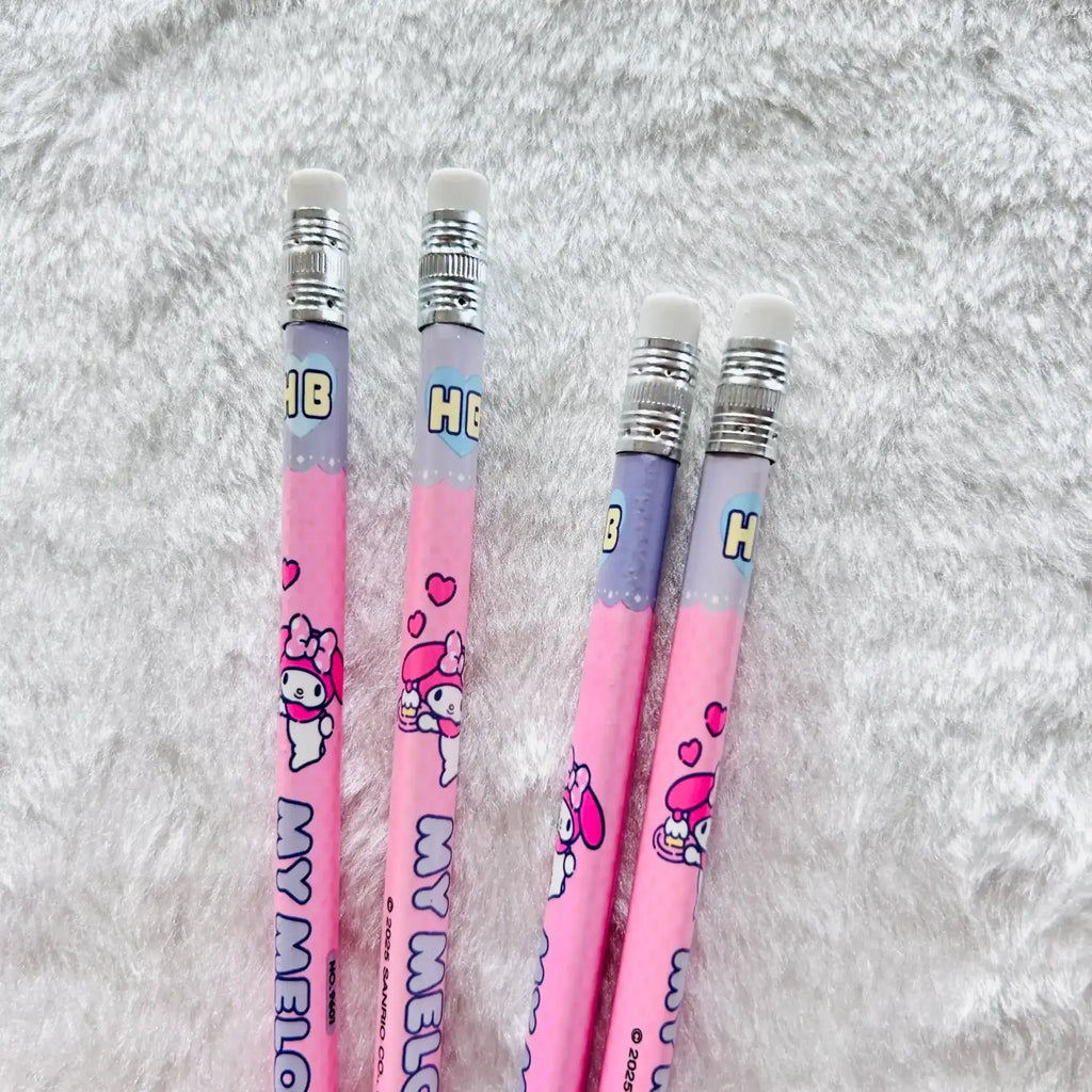 Four pink Hello Kitty HB pencils with white erasers and silver ferrules, arranged on a white faux fur background.