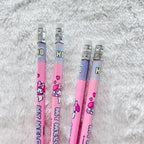 Four pink Hello Kitty HB pencils with white erasers and silver ferrules, arranged on a white faux fur background.