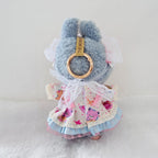 Back view of a Labubu plush doll wearing a ruffled dress with pink cartoon bear prints, white lace trim.