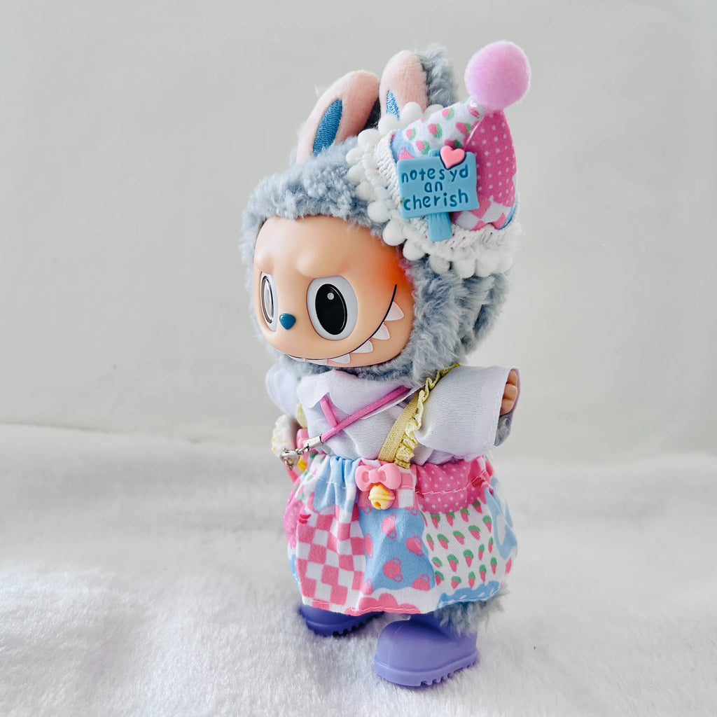 A Labubu wearing a clothing set of blue checkered dress and party cone hat.
