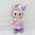 A Labubu  plush doll with a pink-and-blue checkered dress, standing against a soft white background.