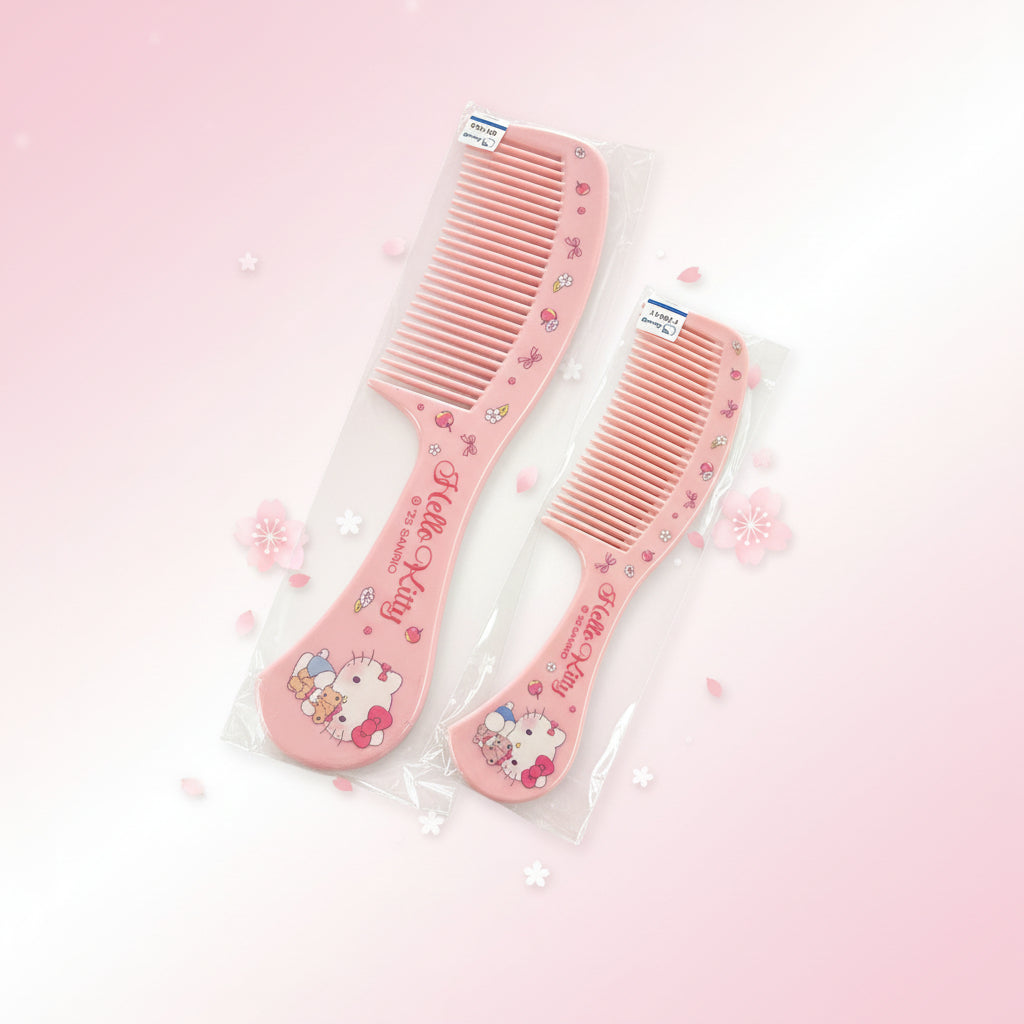 Two pink Hello Kitty hair combs in clear plastic packaging, displayed on a two-toned gray and white surface.