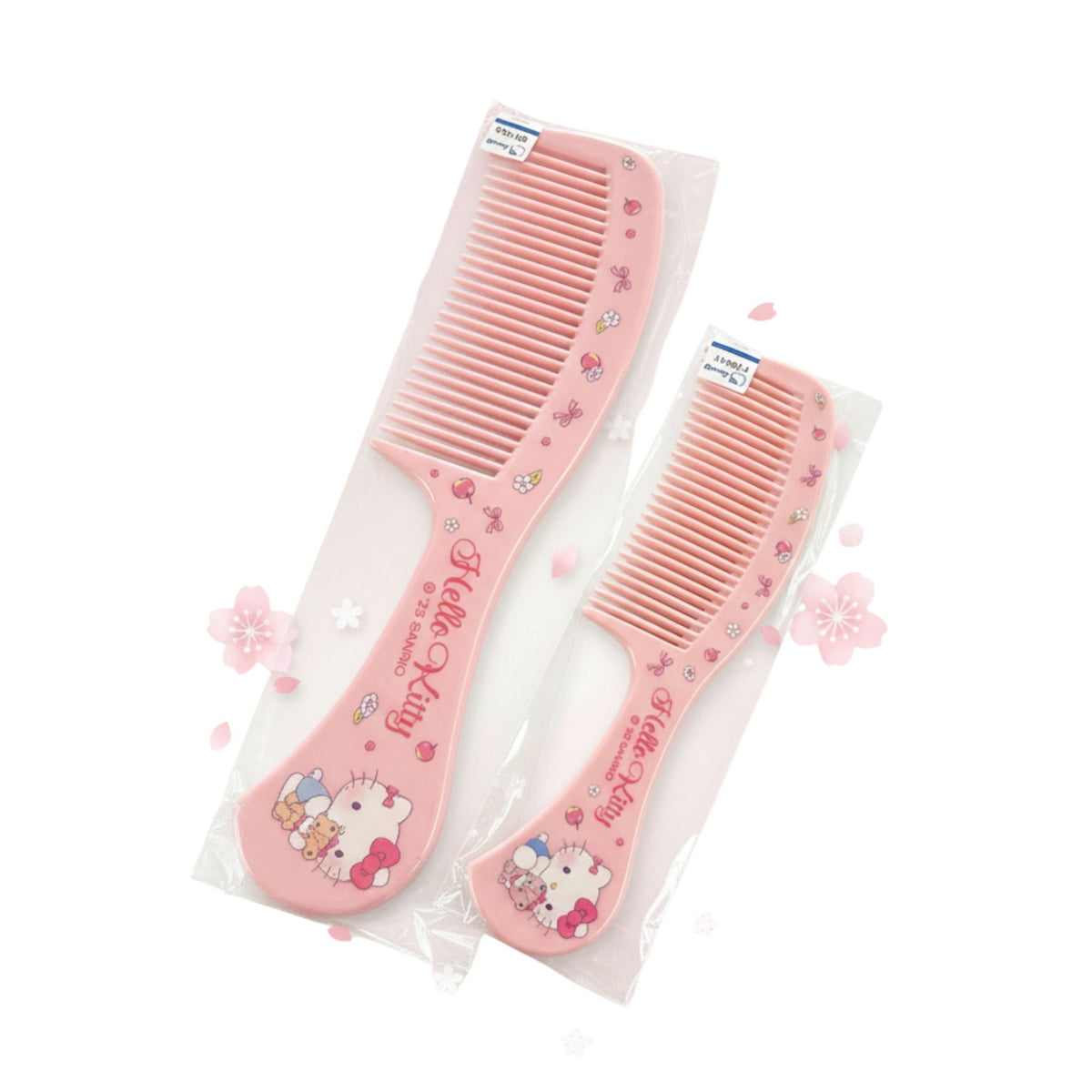 Two pink Hello Kitty hair combs in clear plastic packaging, displayed on a two-toned gray and white surface.