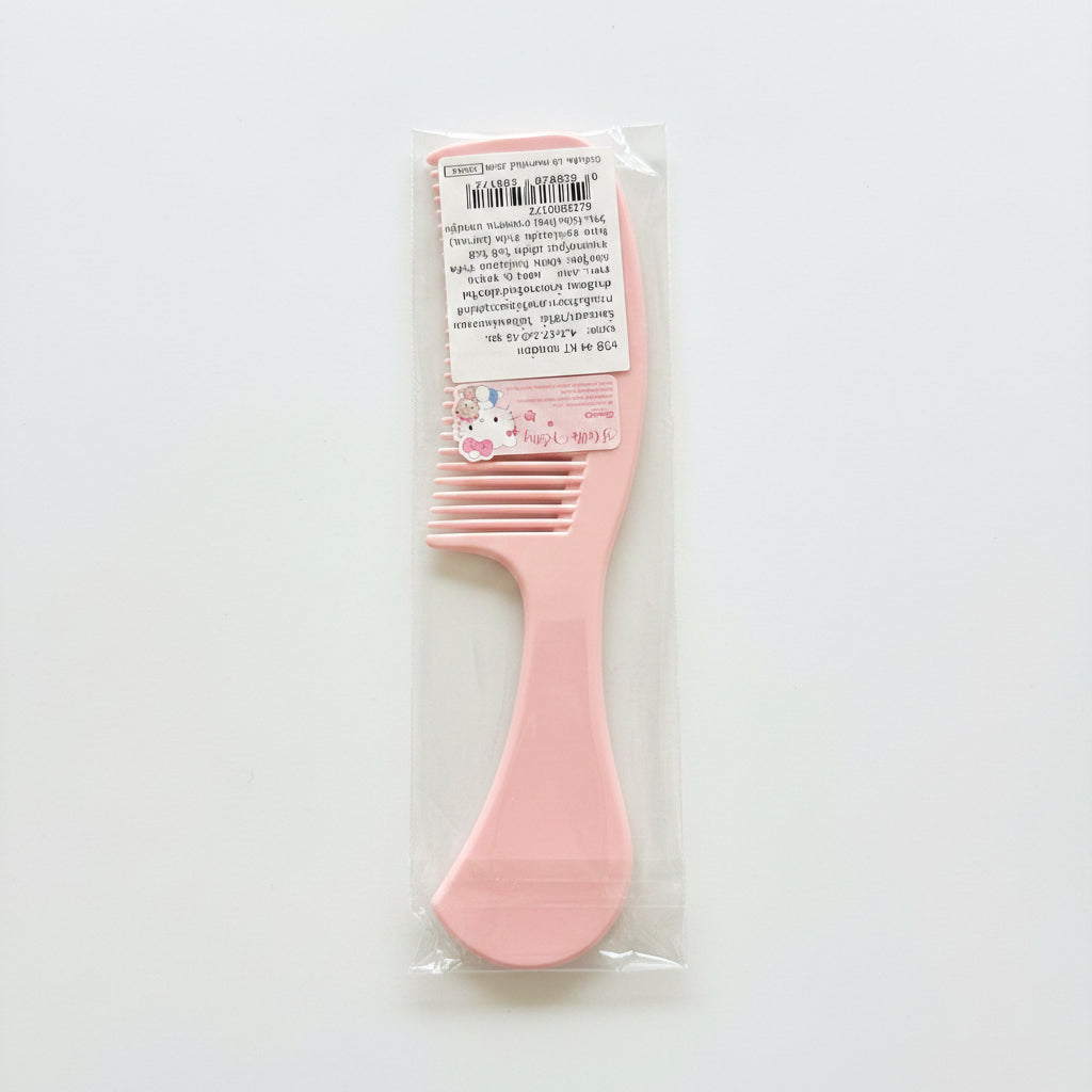 A pink plastic hair comb with a wide-tooth design, packaged in a clear plastic sleeve with a white product label, set against a plain white background.