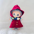 A Labubu doll wearing a bright red hooded coat with buttons and a blue, yellow, and white striped scarf.
