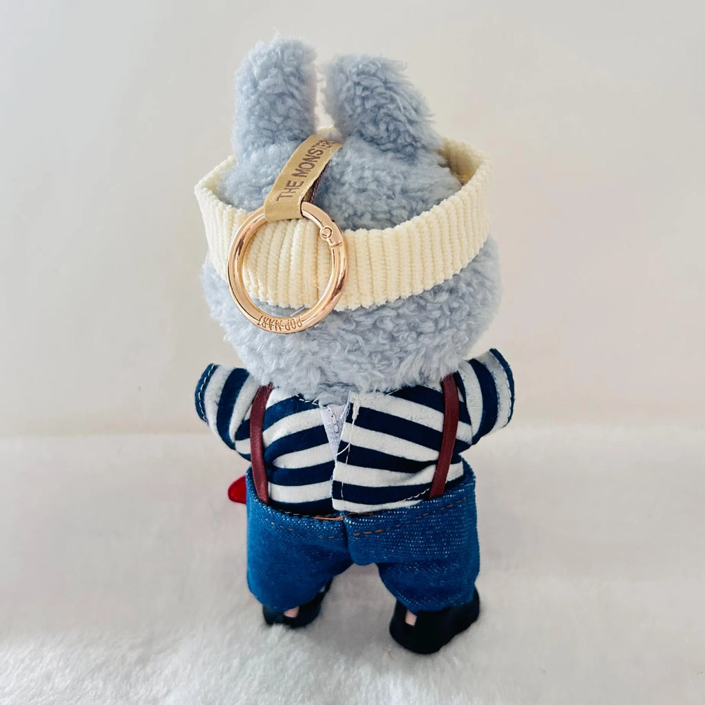 Back view of a Labubu plush doll wearing a navy and white striped shirt, and blue denim-style pants.