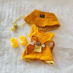 A yellow and white gingham pet outfit set, including a yellow corduroy hat, matching top, shorts, booties, and a small yellow accessory with a bunny charm.